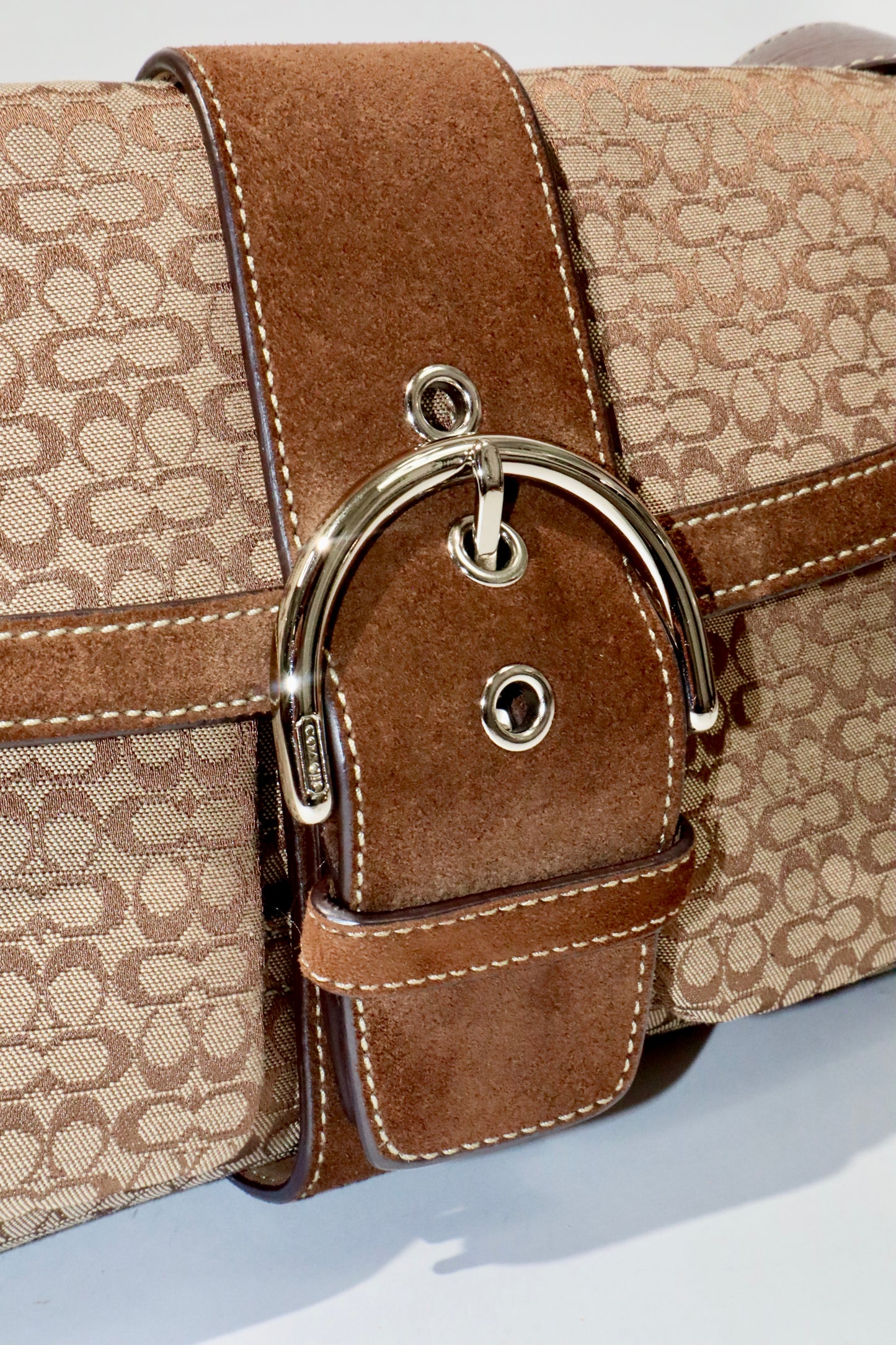 Coach 2005 Vintage Soho Buckle Shoulder Bag in Brown Suede detail showcasing signature buckle and suede texture.
