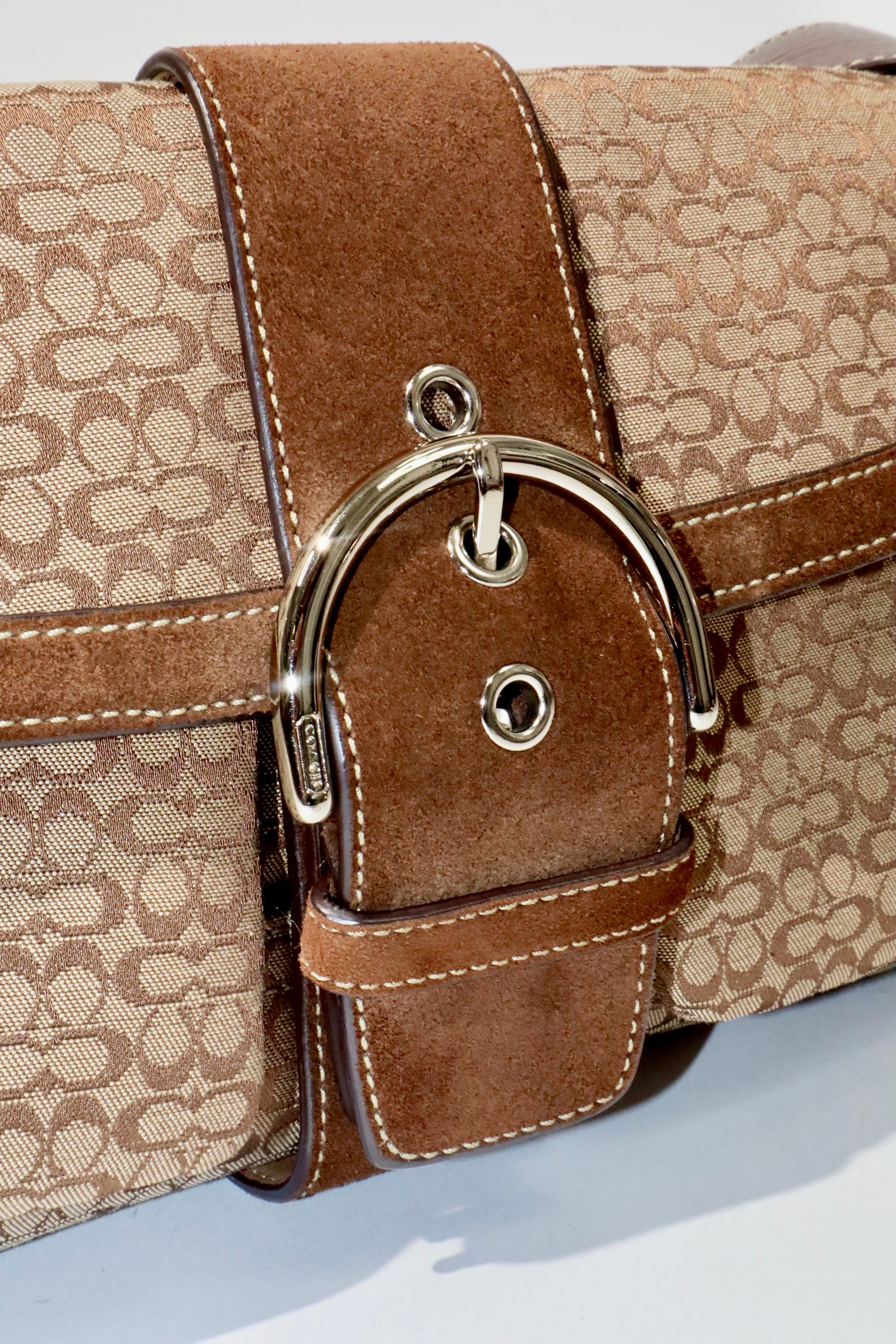 Coach 2005 Vintage Soho Buckle Shoulder Bag in Brown Suede detail showcasing signature buckle and suede texture.