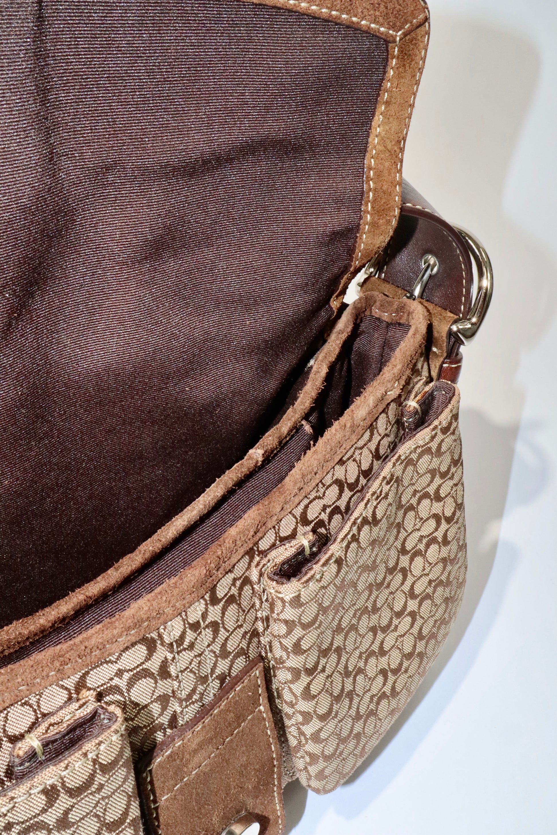 Interior view of the Coach 2005 Vintage Soho Buckle Shoulder Bag in Brown Suede showing compartments and fabric texture.