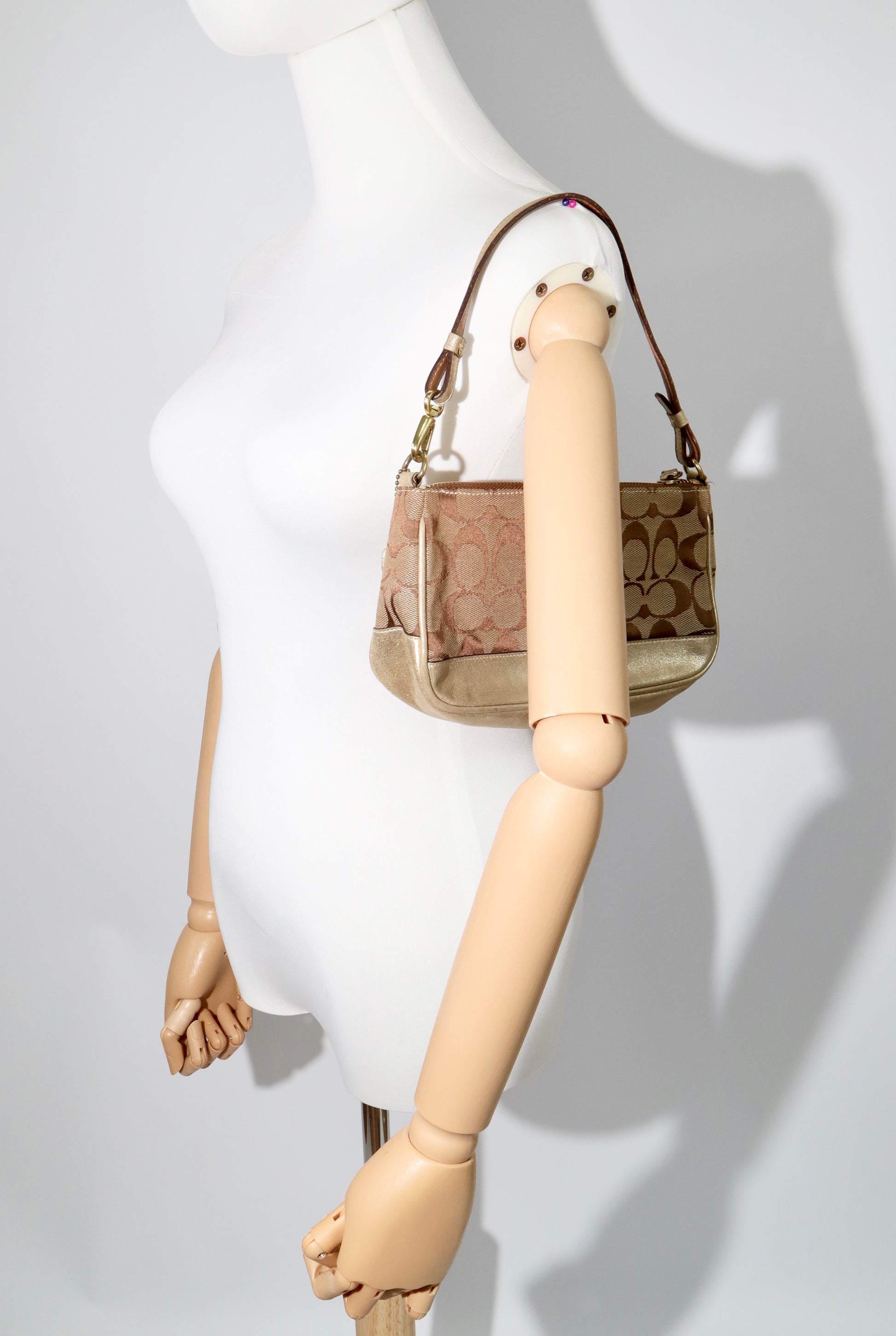 Coach Vintage 2005 Y2K Canvas Mini Pouch Brown & Gold displayed on mannequin for size reference