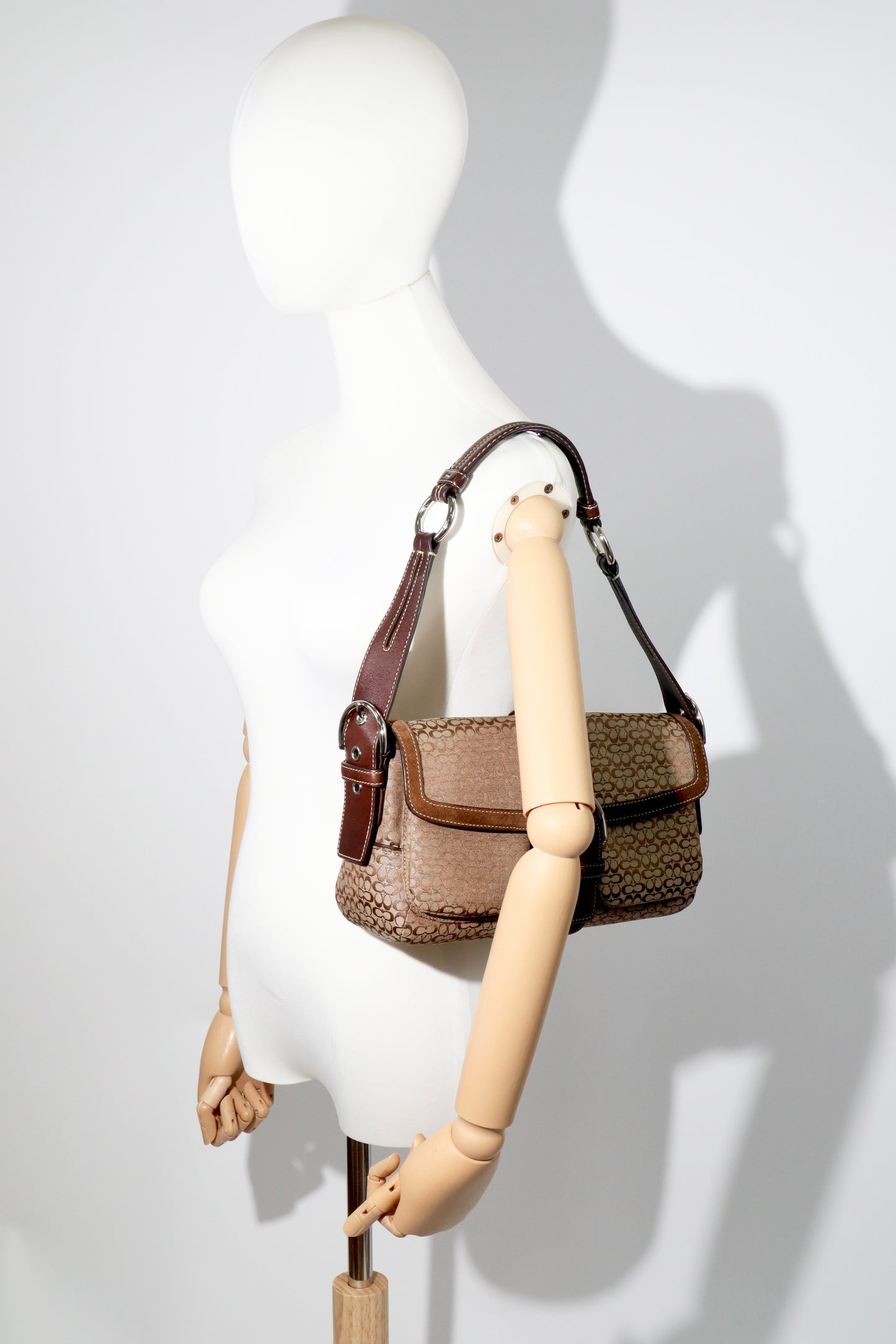 Coach 2005 Vintage Soho Buckle Shoulder Bag in Brown Suede displayed on mannequin for size reference