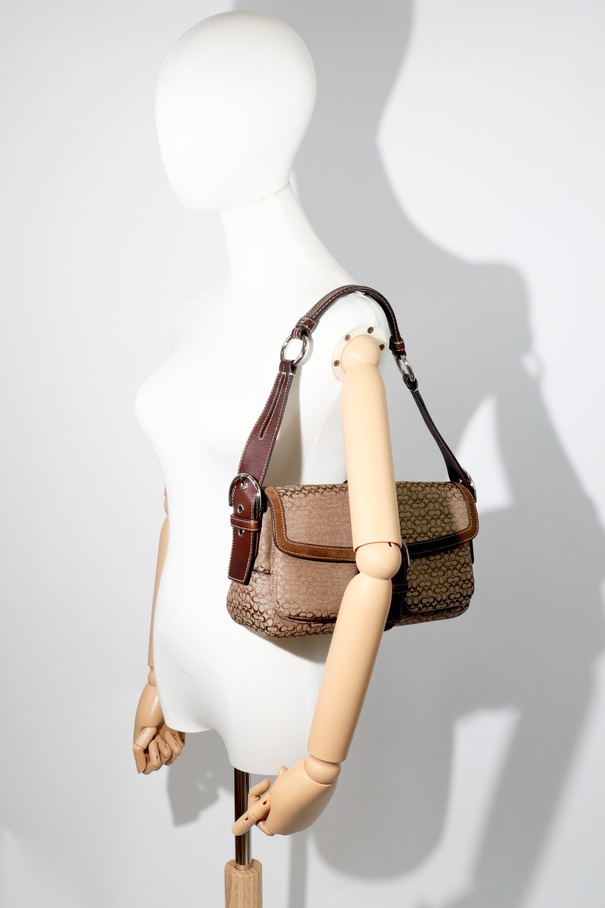 Coach 2005 Vintage Soho Buckle Shoulder Bag in Brown Suede displayed on mannequin for size reference