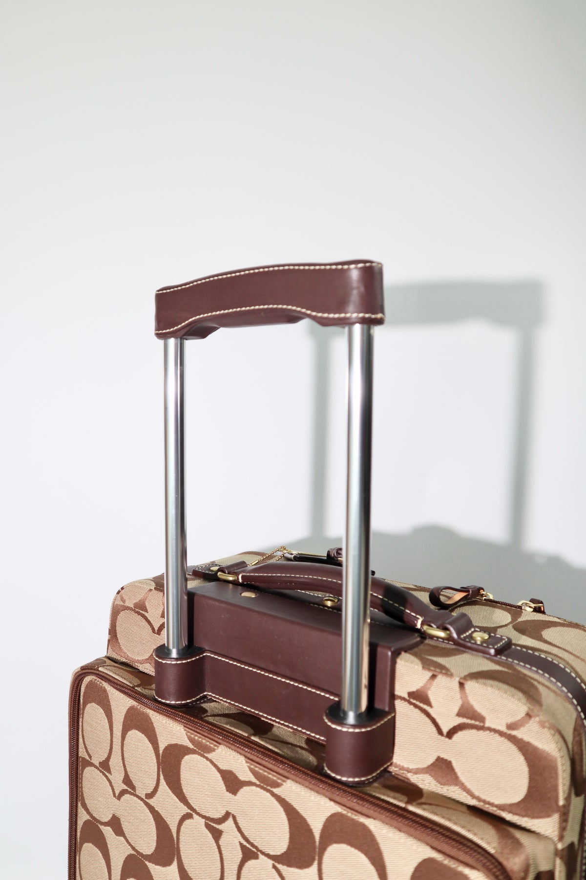 Coach Signature Canvas Rolling Carry-On Suitcase, model F77020