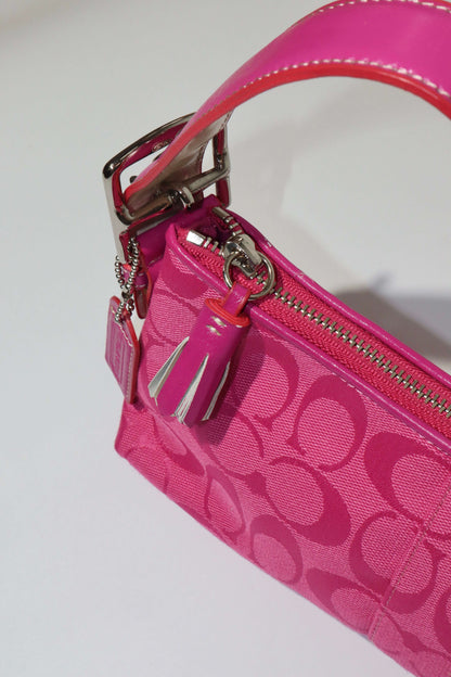Vintage Coach Hot Pink Baguette Demi Shoulder Bag showing the vibrant monogram canvas and hot pink leather trim.