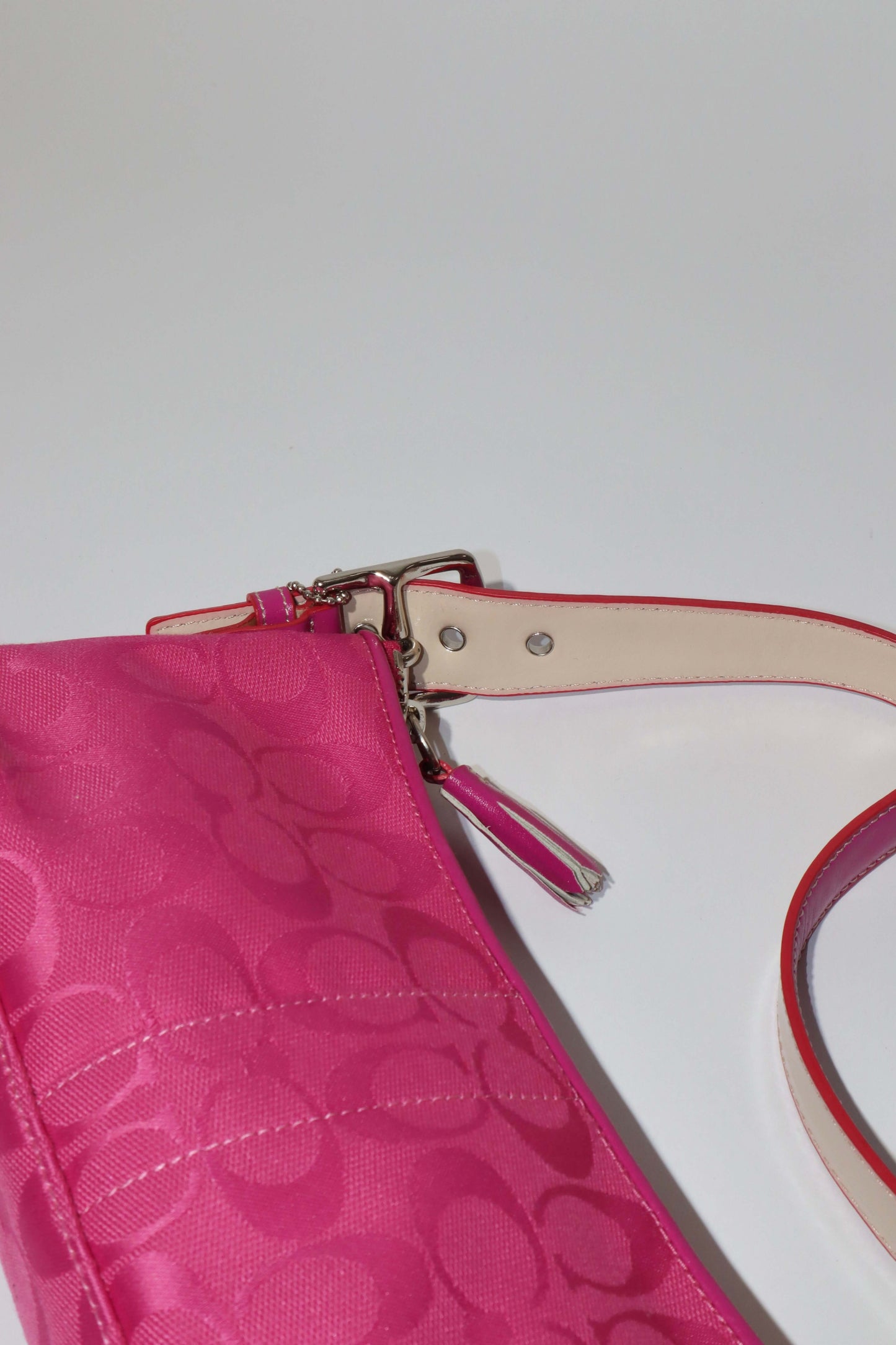 Vintage Coach Hot Pink Baguette Demi Shoulder Bag showcasing vibrant pink canvas and leather details.