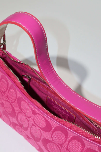 Vintage Coach Hot Pink Baguette Demi Shoulder Bag interior view showcasing vibrant pink canvas and leather trim.
