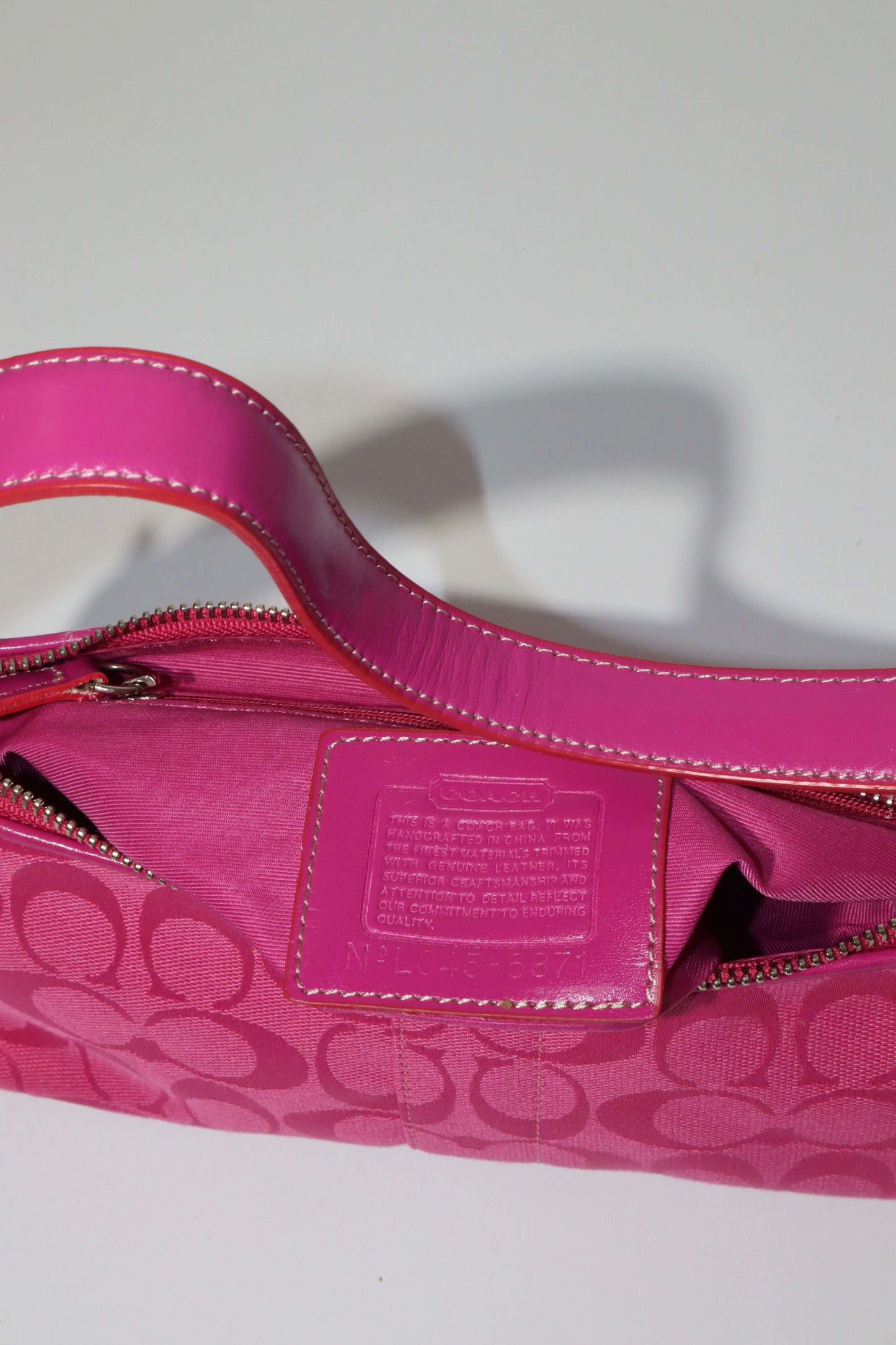 Vintage Coach Hot Pink Baguette Demi Shoulder Bag with signature C monogram canvas and vibrant hot pink leather trim.