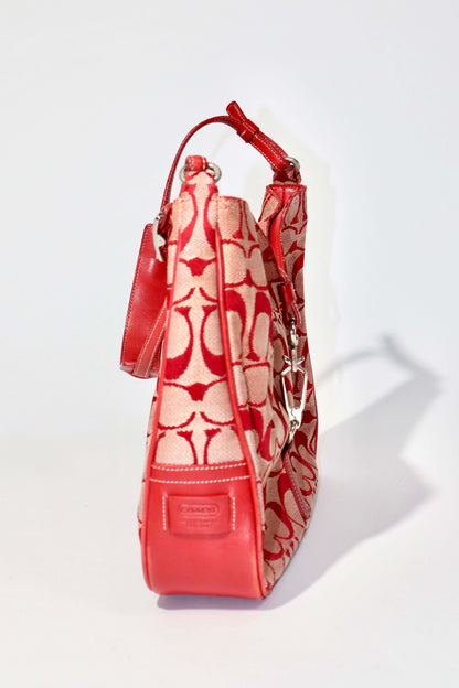 Vintage Coach 2001 Red Clip Tote Shoulder Bag shown from the side, featuring signature monogram canvas and bold red leather trim.