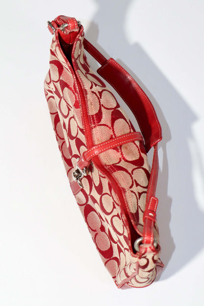 Vintage Coach 2001 Red Clip Tote Shoulder Bag shown from the side, featuring signature monogram canvas and bold red leather trim.