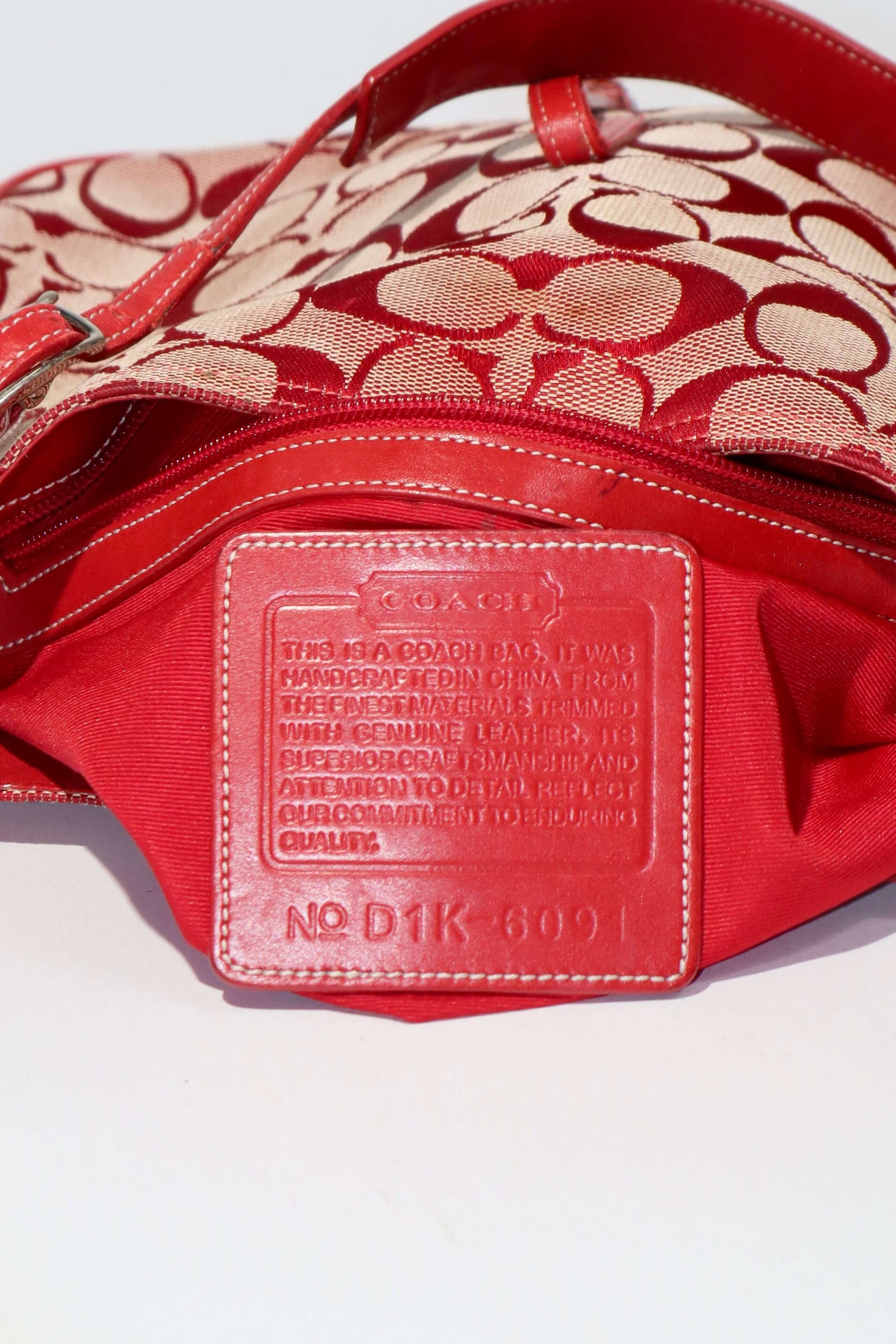 Vintage Coach 2001 Red Clip Tote Shoulder Bag interior detail showcasing red leather and signature C monogram canvas.