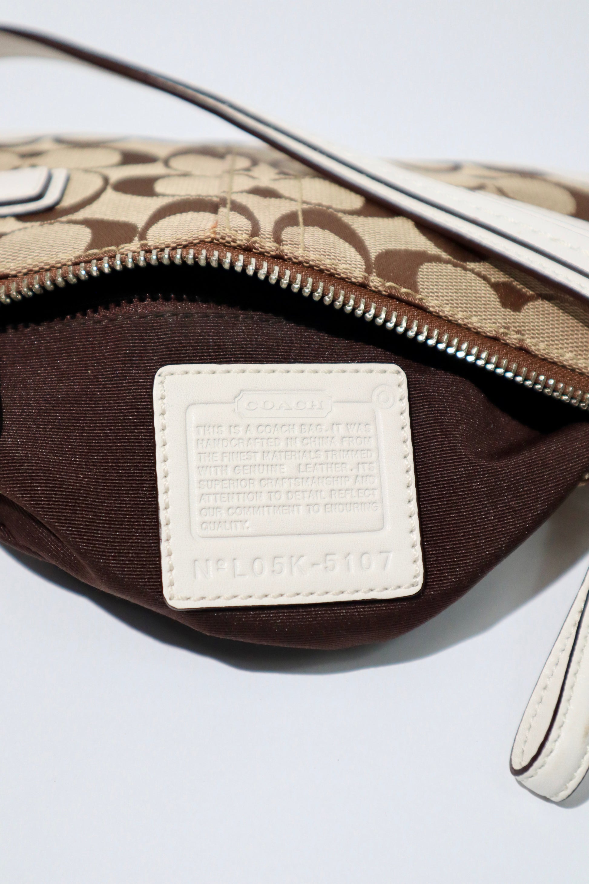 Vintage Coach 2005 Mini Belt Shoulder Bag in Tan & Brown interior view showing label and zipper detail.