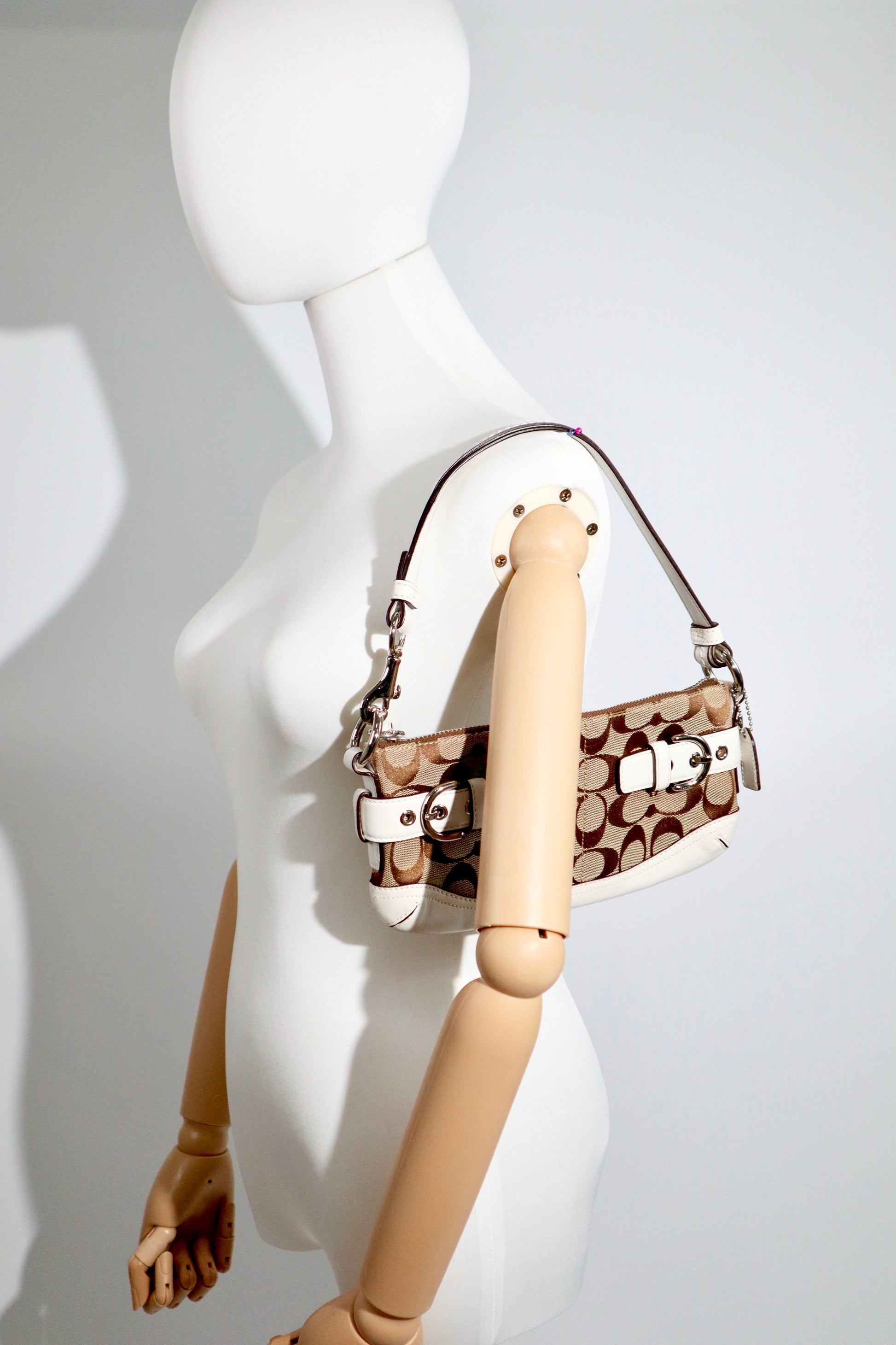 Vintage Coach 2005 Mini Belt Shoulder Bag in Tan & Brown displayed on a mannequin against a minimalist background.