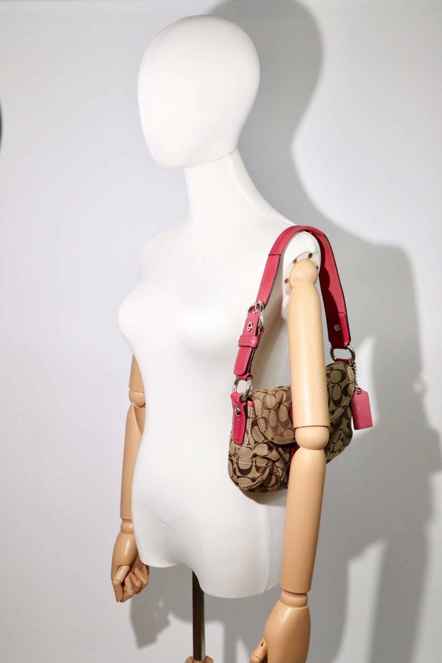 Vintage Coach 2007 Signature Soho Belt Shoulder Bag in Pink worn by mannequin 